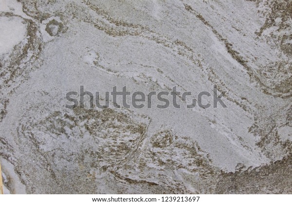 Marble\
pattern on tile floor. Similar to the surface of the moon. Grey\
white and brown color.Close up and zoom texture. Rough surface on\
floor. Free style and natural of stone\
pattern.