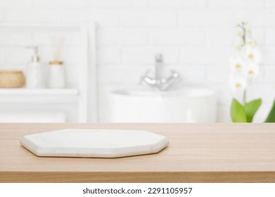 Marble podium for bathing product display on blurred bathroom background