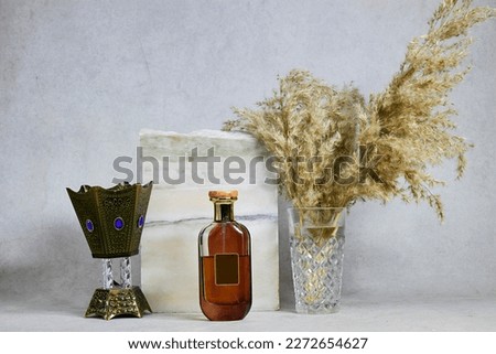 marble podium or stone beauty with amber Oud Arabic oriental perfume near reeds plant vase. Product promotion Beauty cosmetic showcase