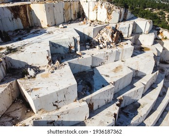 Marble quarry shot from above. Sledges of excavated marble stone material at Mediterranean region of Mersin, Turkey. Aerial view