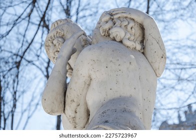 Marble sculpture of kissing Eros and Psyche in a park in the center of Odessa, antique love motif in white marble