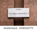 marble sign pointing to Milan