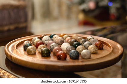 Marble Solitare Board Game On Table. Wooden Board With Marbles For Playing Peg Solitaire.