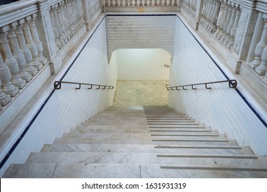 Marble stairs going down into a tunnel