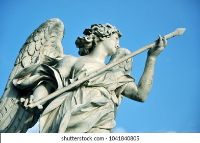 Marble Statue Of Angel Holding The Holy Lance Of Longinus. Sant'Angelo Bridge Balustrade. Rome, Italy