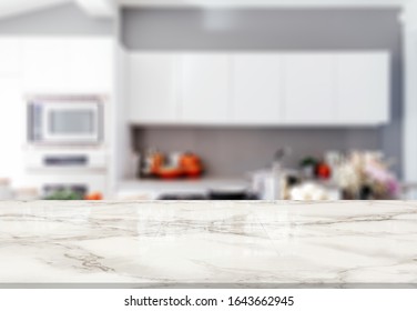 Marble stone table top (kitchen island) on blur kitchen interior background - Shutterstock ID 1643662945