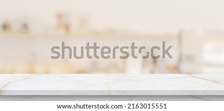 marble table top with blurred kitchen cafe restaurant interior background