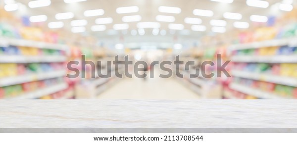 marble table top with\
supermarket grocery store blurred background with bokeh light for\
product display
