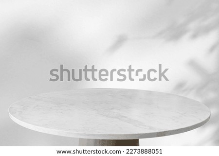 Marble table with tree shadow drop on white wall background for mockup product display