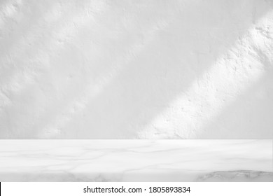 Marble Table with White Stucco Wall Texture Background with Light Beam and Shadow, Suitable for Product Presentation Backdrop, Display, and Mock up. - Shutterstock ID 1805893834
