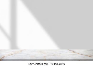 Marble table with window shadow drop on white wall background for mockup product display - Shutterstock ID 2046323810