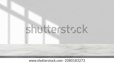 Marble table with window shadow drop on white wall background for mockup product display