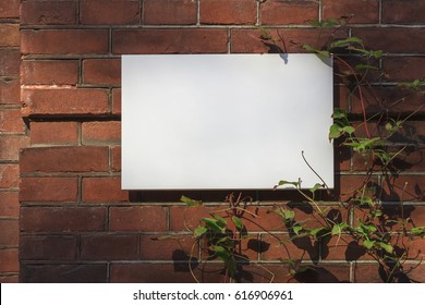 Marble white blank signboard on red brick wall for text or logo mockup.