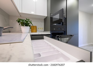 Marble worktop of modern white and dark grey kitchen