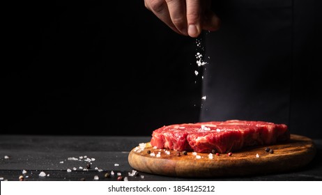 Marbled beef steak and salt from the chef in background with free space for text design or restaurant menu logo. Horizontal photo. Food background. with copy space
