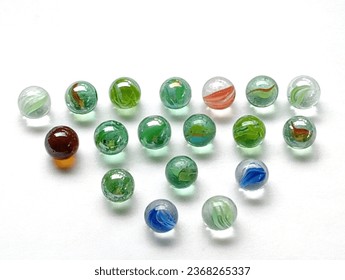 Marbles children toys from the 90s placed on a white background. - Shutterstock ID 2368265337