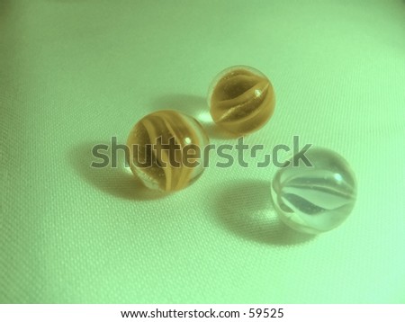marbles on textured green fabric
