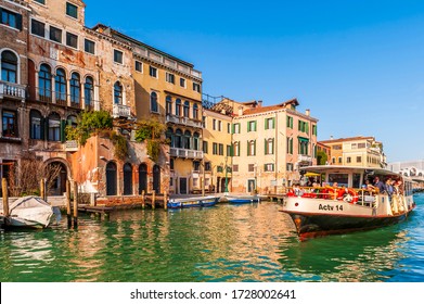 March 06, 2014: Medieval facades on the Grand Canal and a vaporetto in Venice in Veneto, Italy