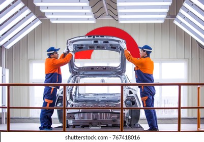 March 14, 2017 Chinese Workers Zhang Quan And Li Ming Are Checking The Outer Frame Of The Car, Representing The Latest Advanced Level In China's Auto Industry