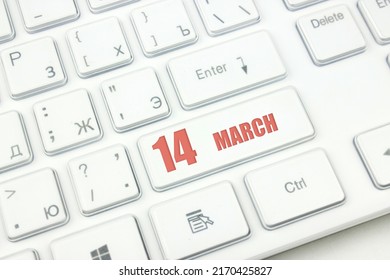 March 14th. Day 14 of month, Calendar date. Cropped view of Modern White Computer Keyboard with calendar date. Concept workspace, freelance, deadline.  Spring month, day of the year concept