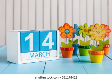 March 14th. Image of march 14 wooden color calendar with flower on white background.  Spring day