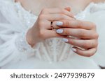 March 15, 2021, Paris, France. The delicately adorned hands of a bride showcase a sparkling wedding band, symbolizing love and commitment.