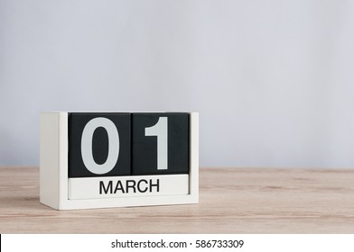 March 1st. Day 1 of month, wooden color calendar on white background. Spring time, empty space for text.
