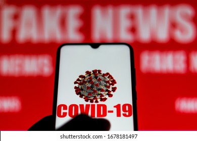 March 20, 2020, Brazil. In This Photo Illustration The Covid-19 Virus (coronavirus) Is Displayed On The Smartphone Screen. The Word Fake News Appears In The Background.