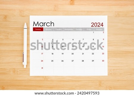 March 2024 calendar page on wooden background.
