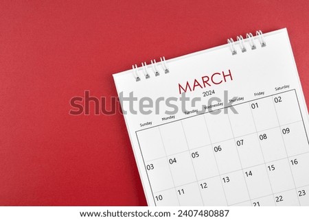 March 2024 desk calendar on red color background.