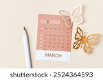 March 2025 calendar card for the organizer to plan and reminder and butterfly paper on yellow background.