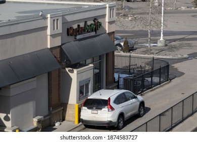 March 22 2020 - Calgary Alberta Canada - Car Using Drive Through At Fast Food Resturant