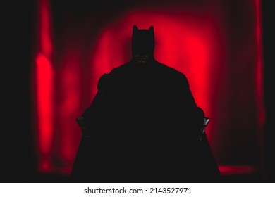 MARCH 26 2022: Shadow of DC Comics caped crusader Batman in an alleyway of Gotham City - Mattel action figure