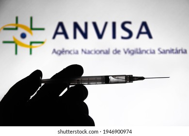 March 31, 2021, Brazil. In This Photo Illustration The Medical Syringe Is Seen With National Health Surveillance Agency (Anvisa) Company Logo Displayed On A Screen In The Background