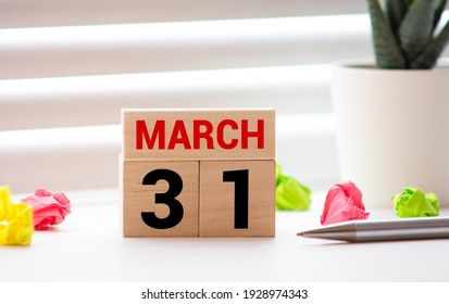 MARCH 31st. Image of MARCH 31 wooden color calendar on white wood wall background. empty space for text
