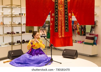 March 8, 2016: South Korea, Incheon International Airport. Traditional Cultural Experience Center, Passenger Terminal - Girl In National Costume Playing A  Folk Musical Instrument