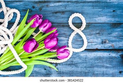 March 8 Background. On A Wooden Table: Tulips And Number 8