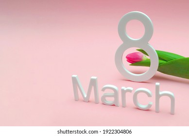 March 8, international women's day. Number eight against a background of tulips against a pink uniform background, place for text. Suitable for advertising, postcards, congratulations.