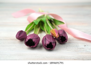 March 8, Purple Flowers, Tulips On A Light Wooden Table. Side View. Concept Of Festive Backgrounds, March 8, Spring.