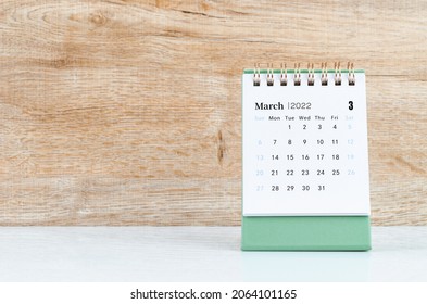 The March calendar 2022 on wooden background.