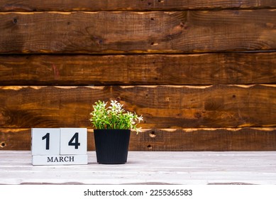 March calendar with number  14. Planner copy space on a wooden brown background. March number icon. Place for text background calendar