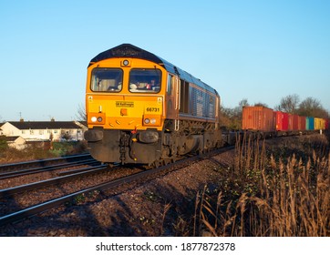 March, Cambridgeshire, UK December 2020. GBRf GMC Diesel Locomotive 66731 Passing Silt Drove, March With A Loaded Container Train For Felixstowe Docks In The Pre Christmas And Pre Brexit Rush