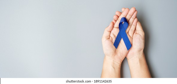 Image of dark blue colon cancer ribbon on white background from