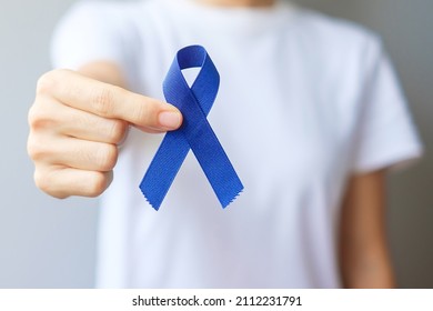 March Colorectal Cancer Awareness month, Woman holding dark Blue Ribbon for supporting people living and illness. Healthcare, hope and World cancer day concept - Powered by Shutterstock