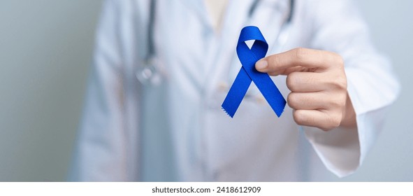 March Colorectal Cancer Awareness month, doctor with dark Blue Ribbon for supporting people living and illness. Healthcare, hope and World cancer day concept - Powered by Shutterstock