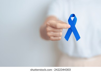 March Colorectal Cancer Awareness month, doctor with dark Blue Ribbon for supporting people living and illness. Healthcare, hope and World cancer day concept - Powered by Shutterstock