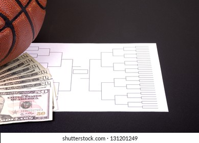 A March Madness Tournament Bracket With A Basketball And Fanned Money