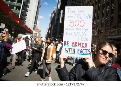 March For Our Lives: A Woman Holds A Sign That References Sandy Hook School Shooting And Says Be Armed With Facts During The March To End Gun Violence On 6th Ave, NEW YORK MAR 24 2018.