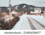 March in the village of Mansky, the snow began to melt, wooden cottages