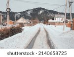 March in the village of Mansky, the snow began to melt, wooden cottages